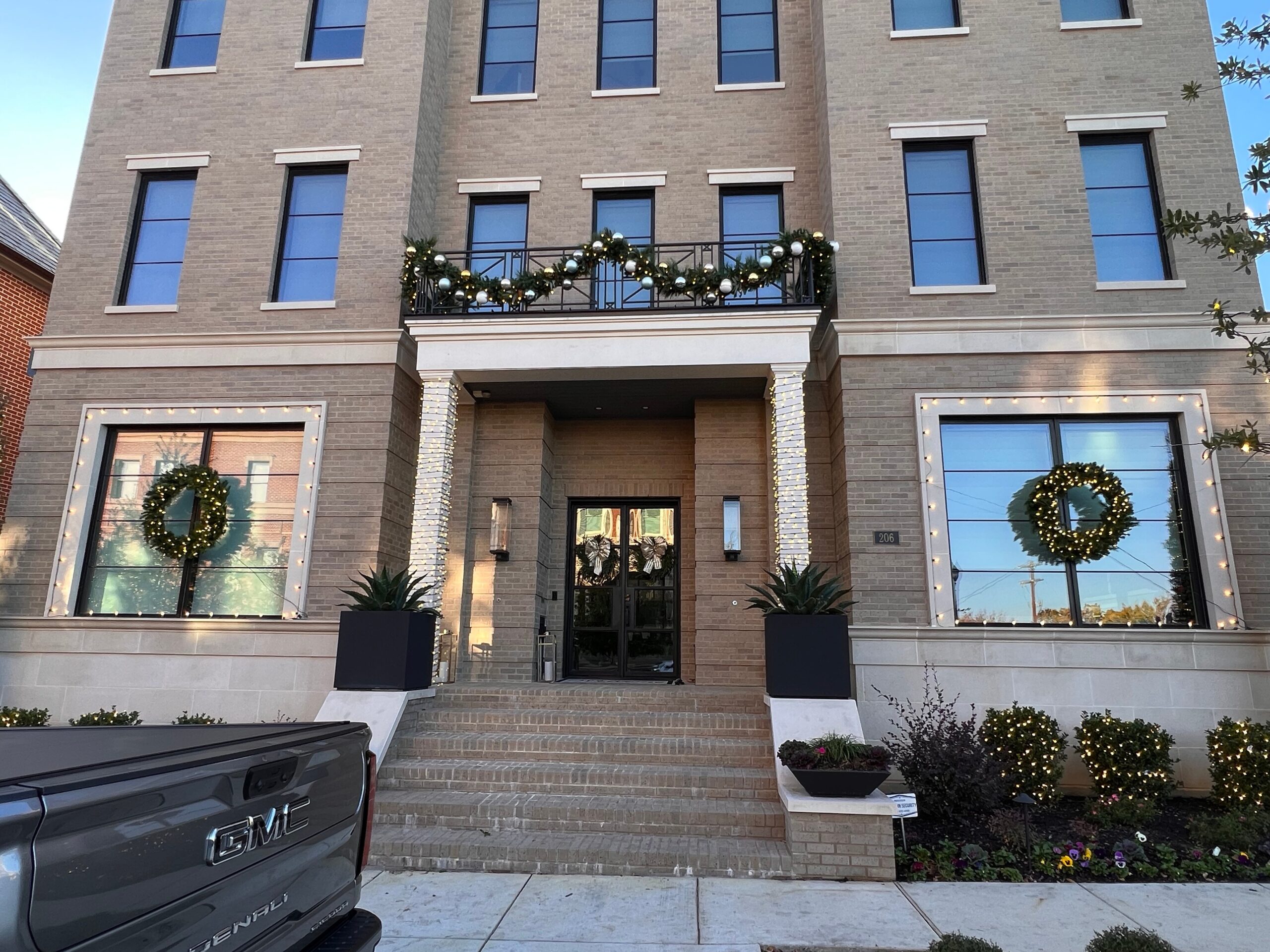 Decorative garland installed along balcony railing by professional Christmas light installer in Dallas.